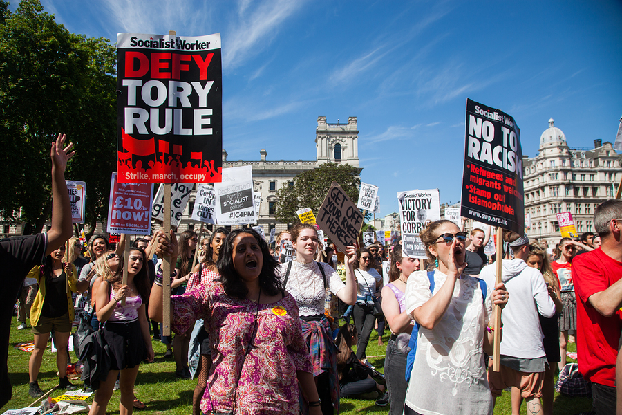 London, UK - June 10 2017: Unidentified protesters at Westminster Palace expressing their anger at Theresa May's government and her alliance with the Democratic Unionist Party, London, UK